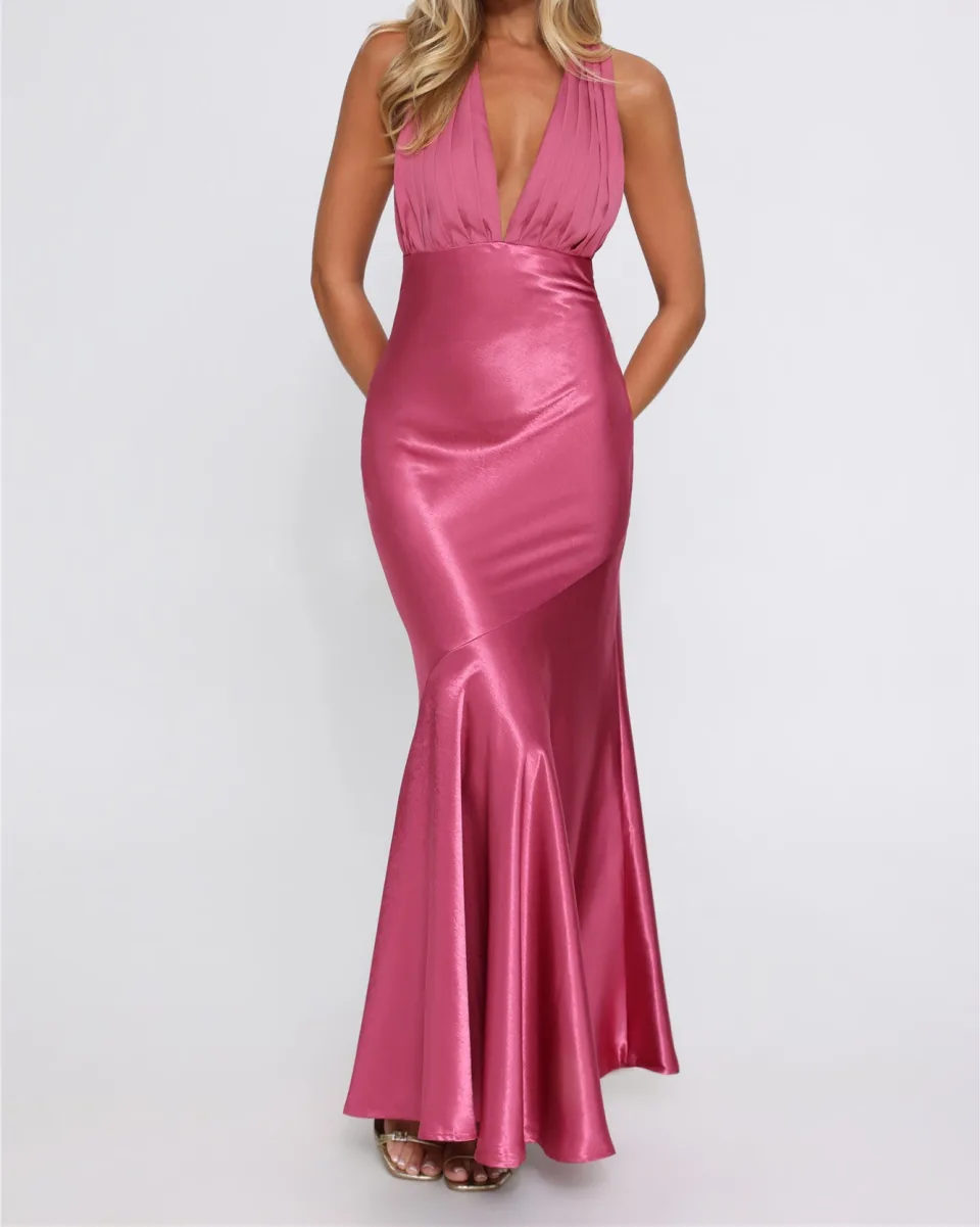 A magenta satin maxi dress with a deep V neckline, fitted through the hip and flaring at the hem.